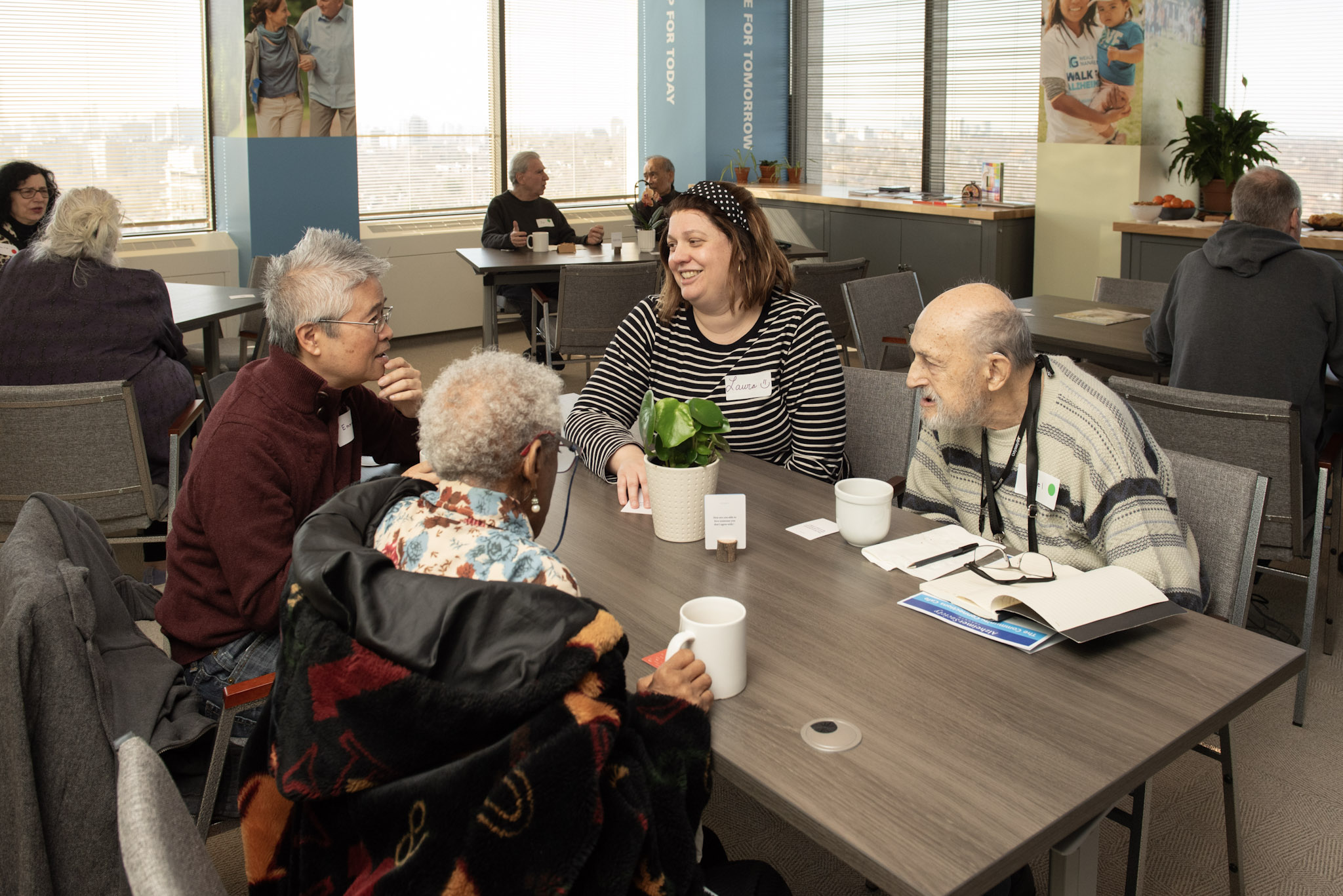 Clients and staff from Alzheimer Society of Toronto talking around a table