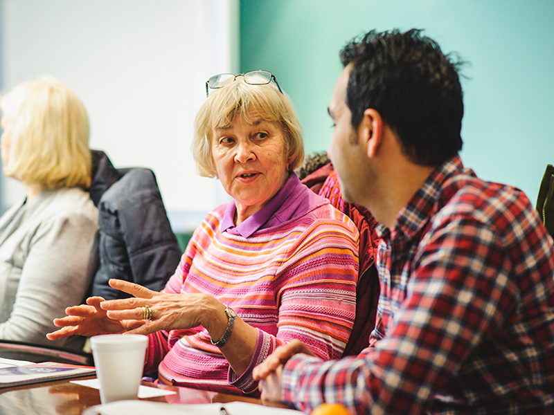 Two adults talking in a support group