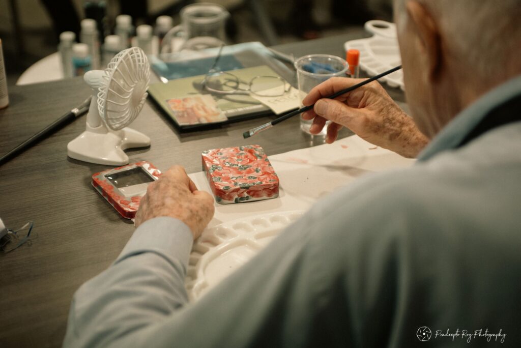 Senior man doing an art project with paint