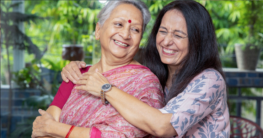 Adult mother and daughter South Asian hugging