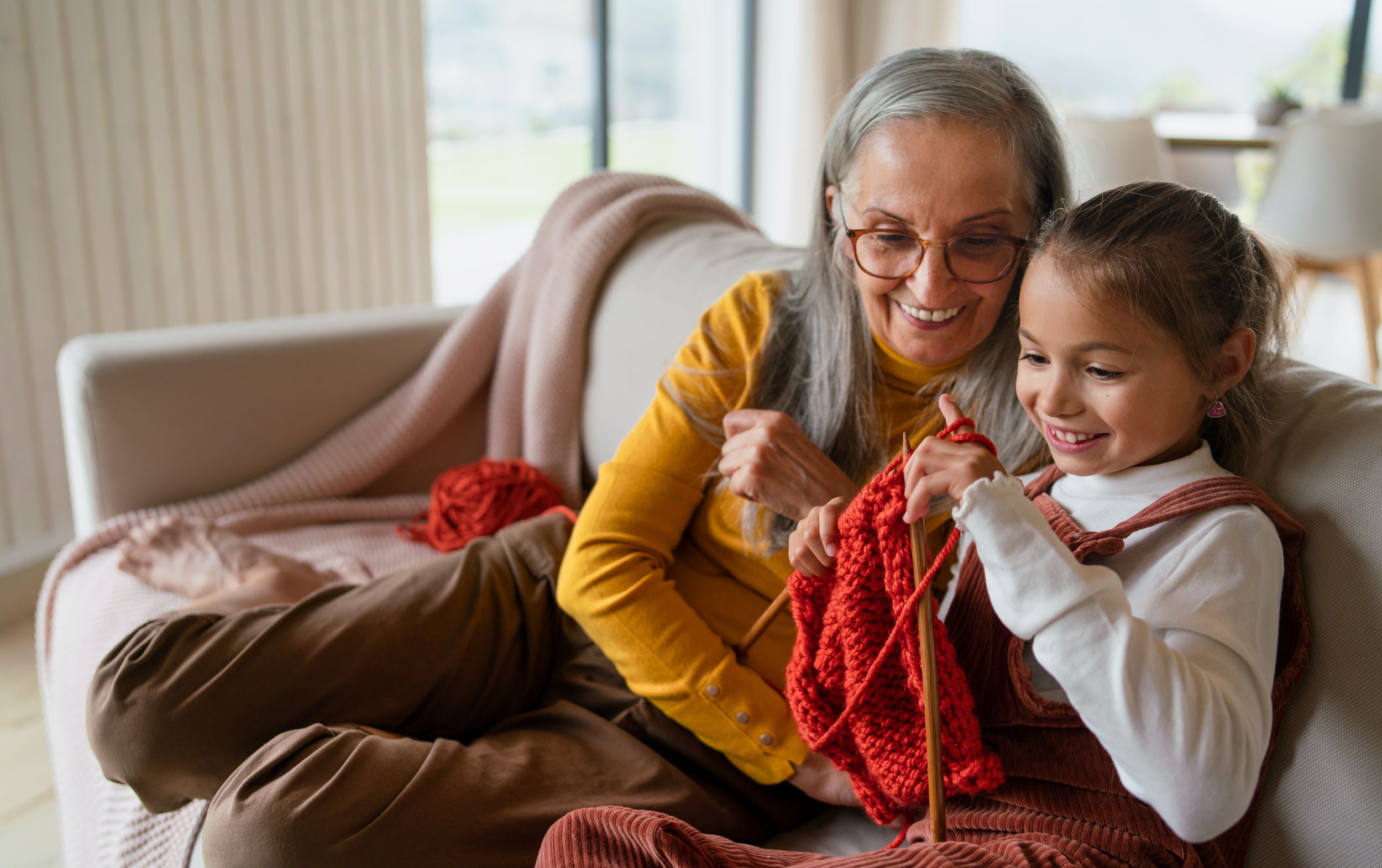 first nations grandmother and her granddaughter knitting