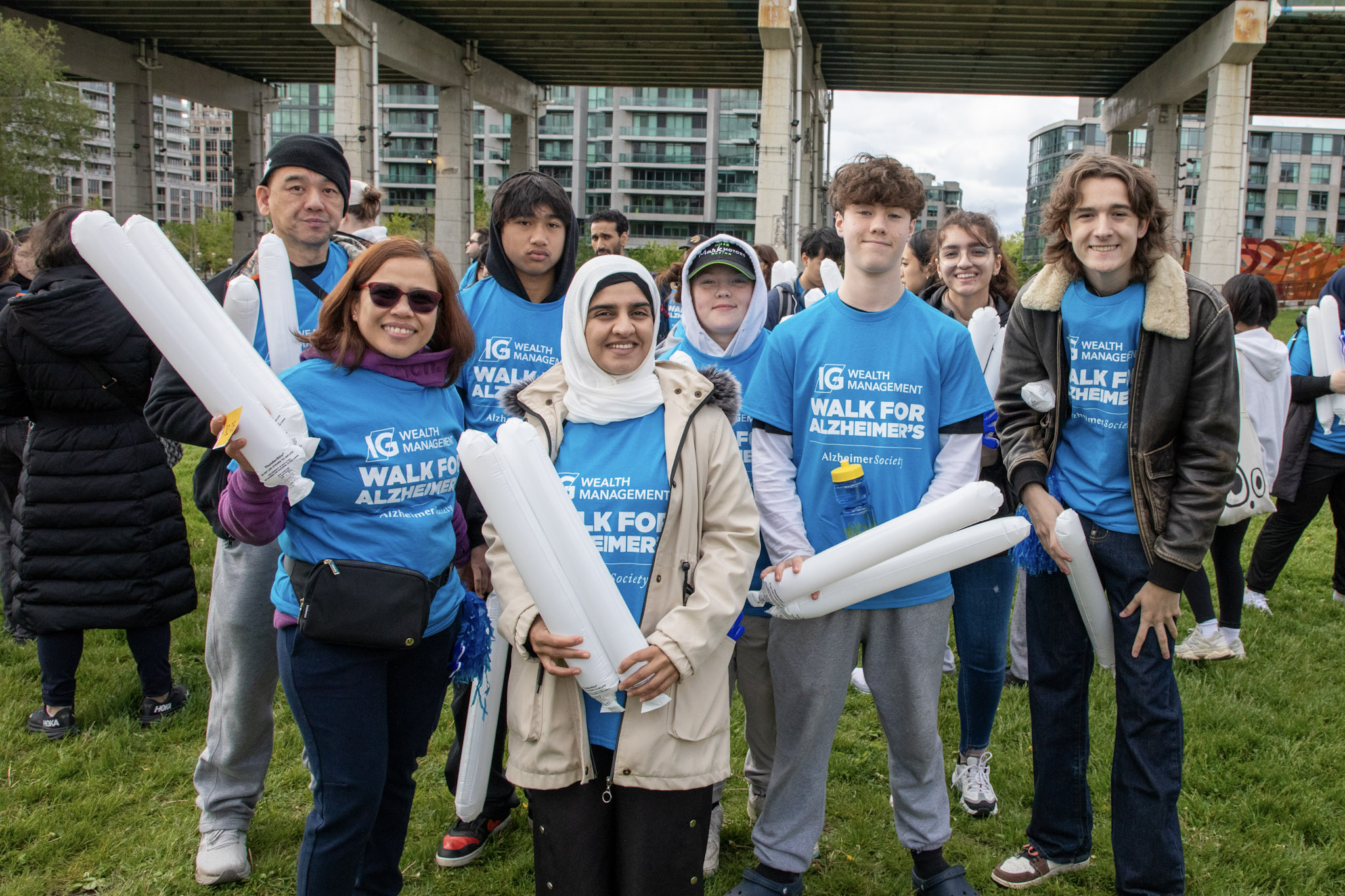 A group of individuals who participated in the Walk for Alzheimer's posing in front of the Gardiner Expressway.