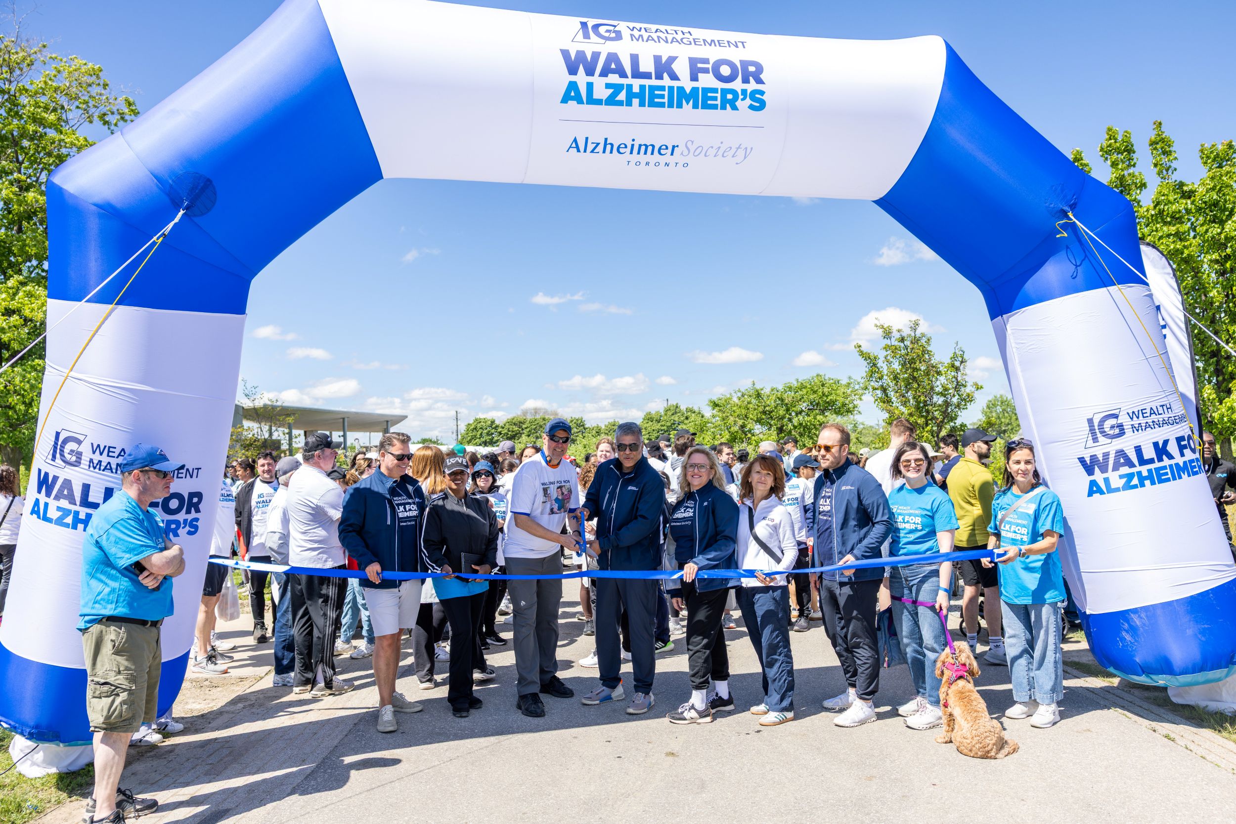 An image of the start line at the 2026 IG Wealth Management walk for Alzheimer's, with board members and Dave Spedding cutting the ceremonial ribbon.